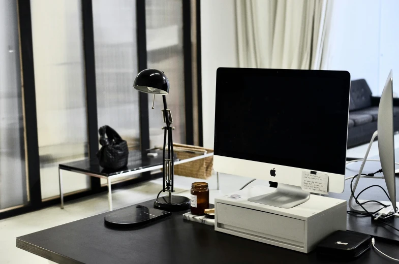 a computer monitor sitting on top of a desk, a computer rendering, unsplash, minimalism, small room in tokyo, ignant, ornate designs on desk, office/thrift store/social hall