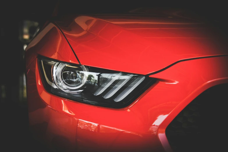 a close up of a red car's headlight, pexels contest winner, car trading game, mustang, avatar image, instagram photo
