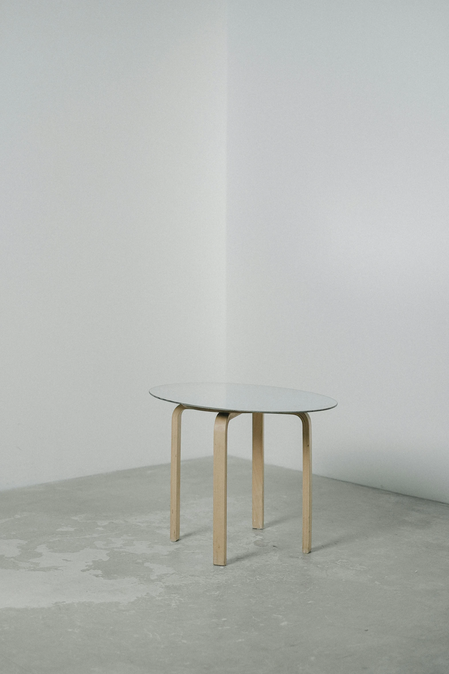 a white table sitting on top of a cement floor, by Harvey Quaytman, birch, soft oval face, (mist), 4 legs