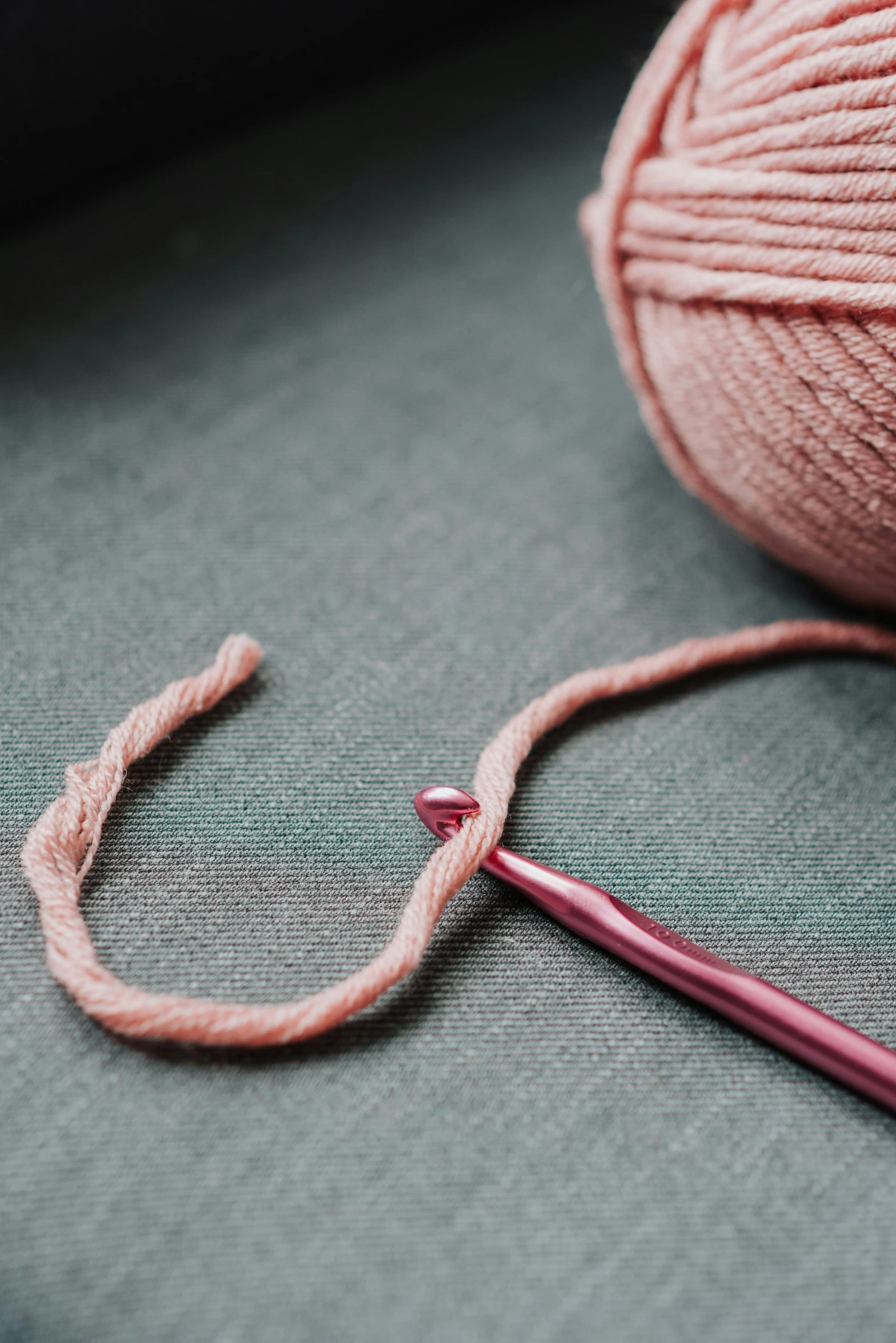 a ball of yarn next to a crochet hook, trending on pexels, faded pink, super precise detail, jewelry, exploitable image