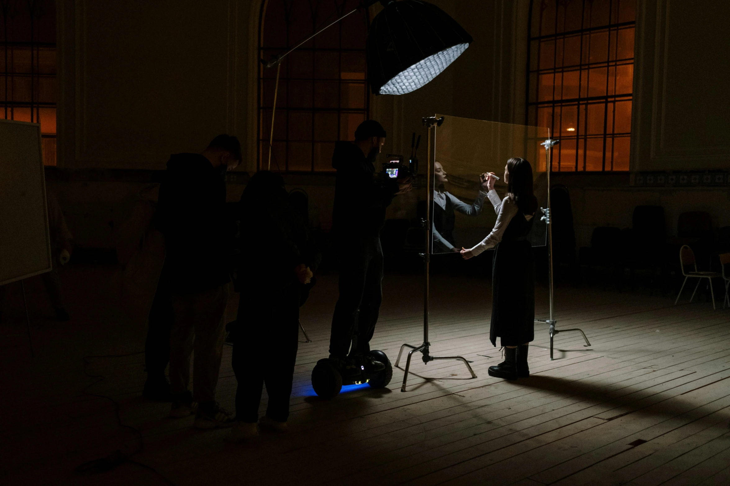 a group of people standing in a dark room, hyperrealism, behind the scenes photo, hammershøi, 8 k studio lighting, scene set in a church