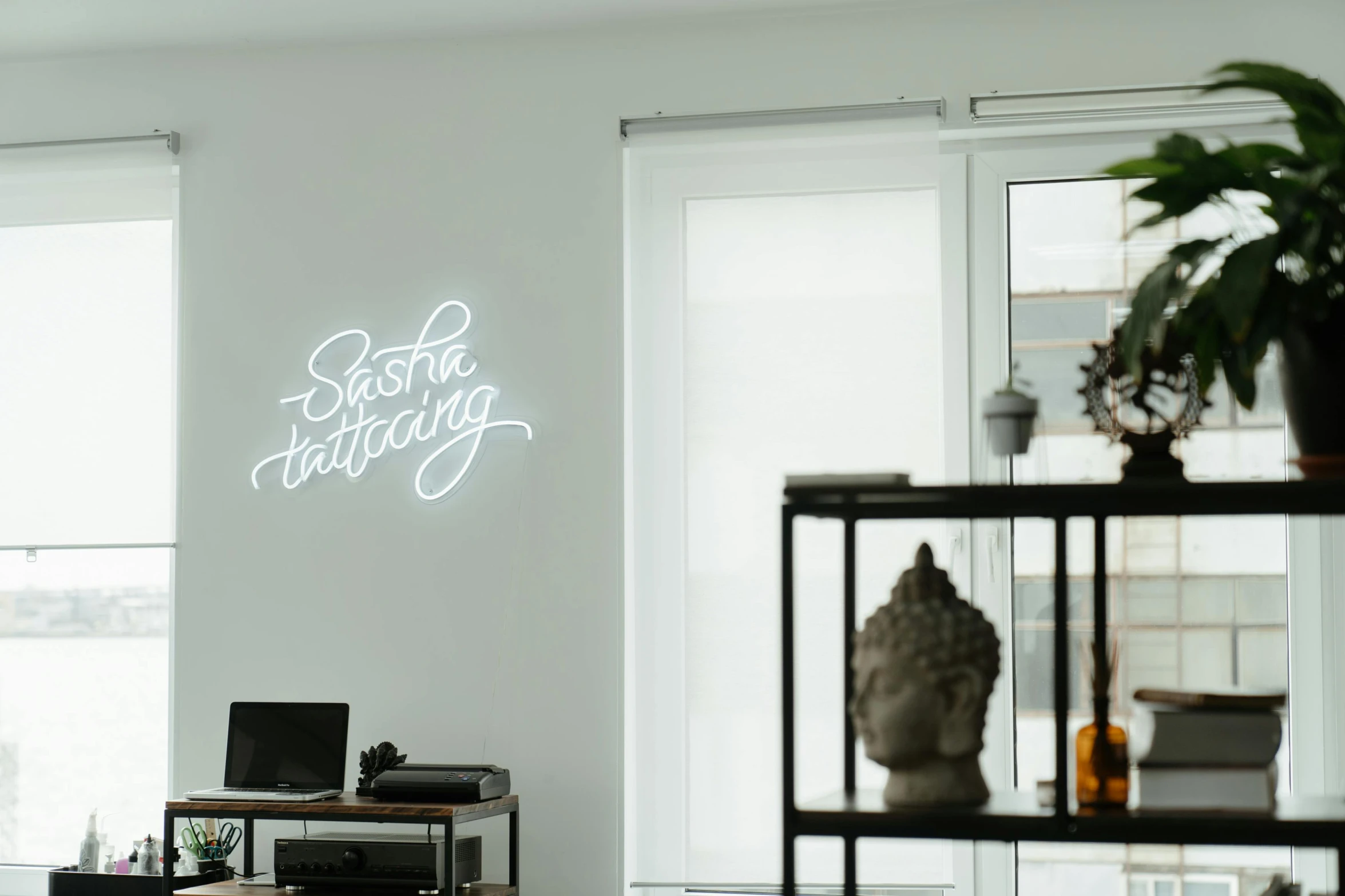 a living room filled with furniture and a neon sign, a tattoo, by Sebastian Spreng, trending on unsplash, white accent lighting, interior white wall, sat in an office, caligraphy