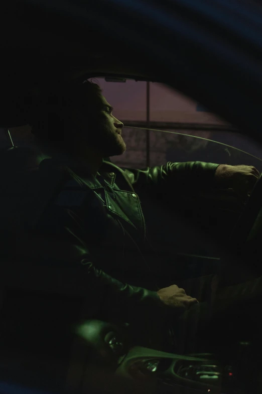 a man sitting in the driver's seat of a car, an album cover, inspired by Elsa Bleda, phosphorescent, digital image, nightlife, profile picture