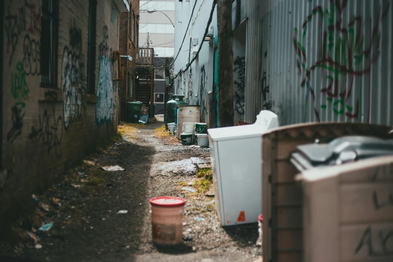 a trash can sitting on the side of a building, pexels contest winner, graffiti, shady alleys, in a row, tins of food on the floor, landscape photo