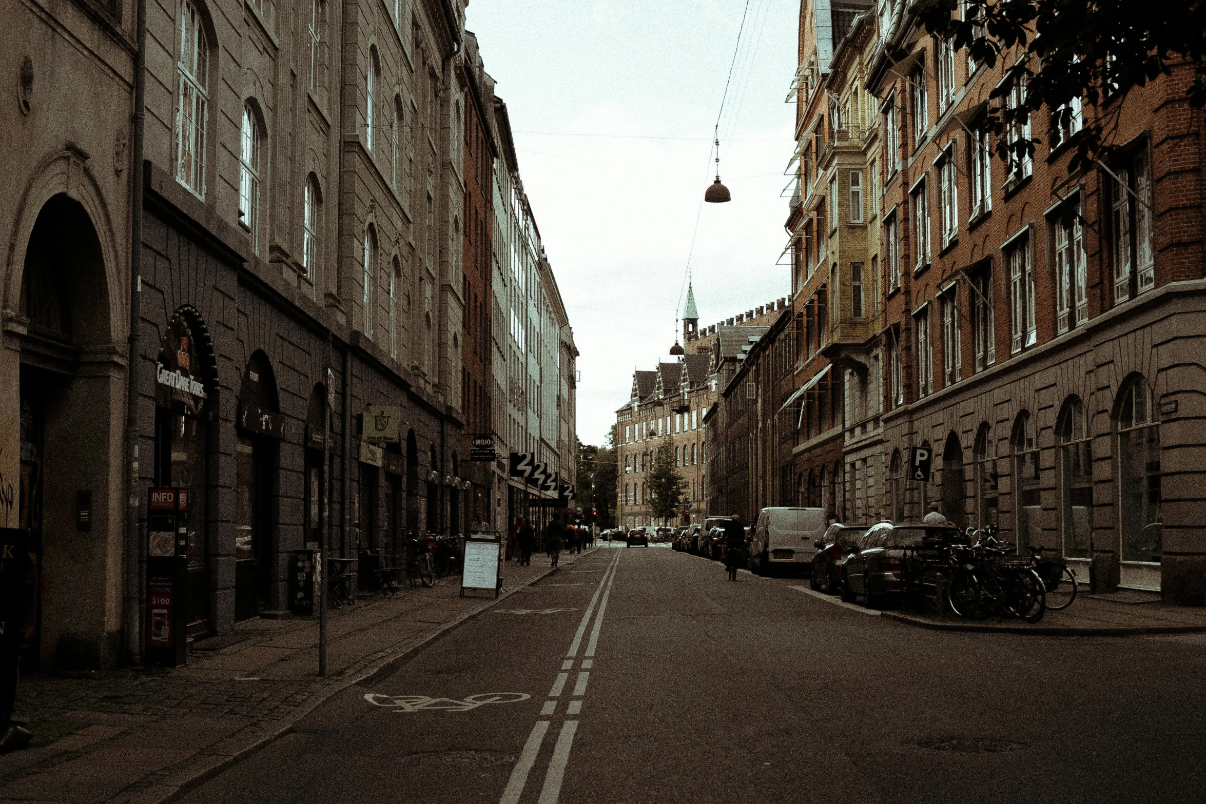 a narrow city street lined with tall buildings, by Jesper Knudsen, pexels contest winner, hammershøi, square, historical photo, brown