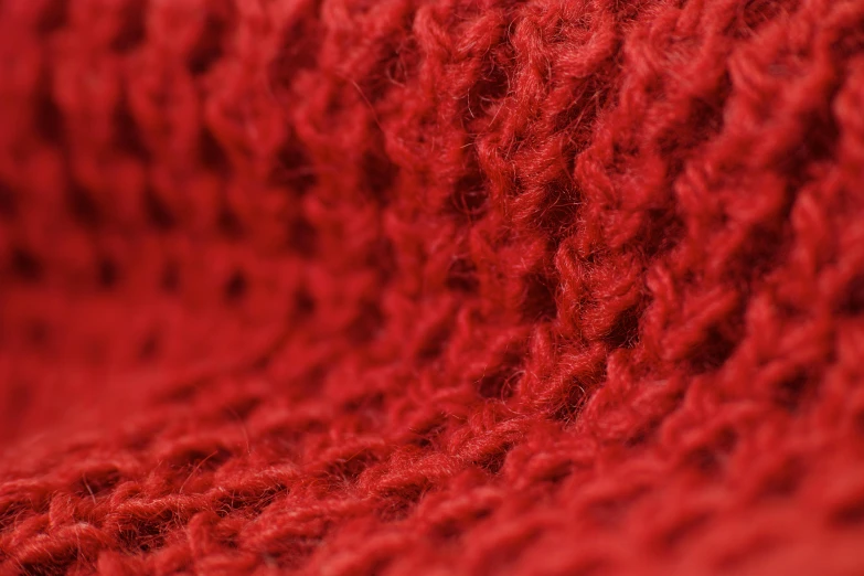 a close up of a red knitted blanket