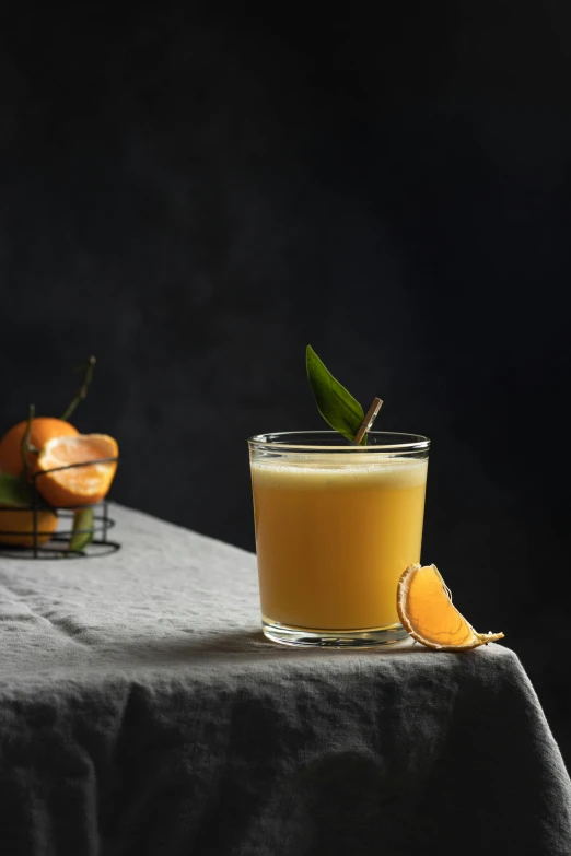 a glass of orange juice sitting on top of a table, renaissance, on a gray background, botanicals, bartending, square