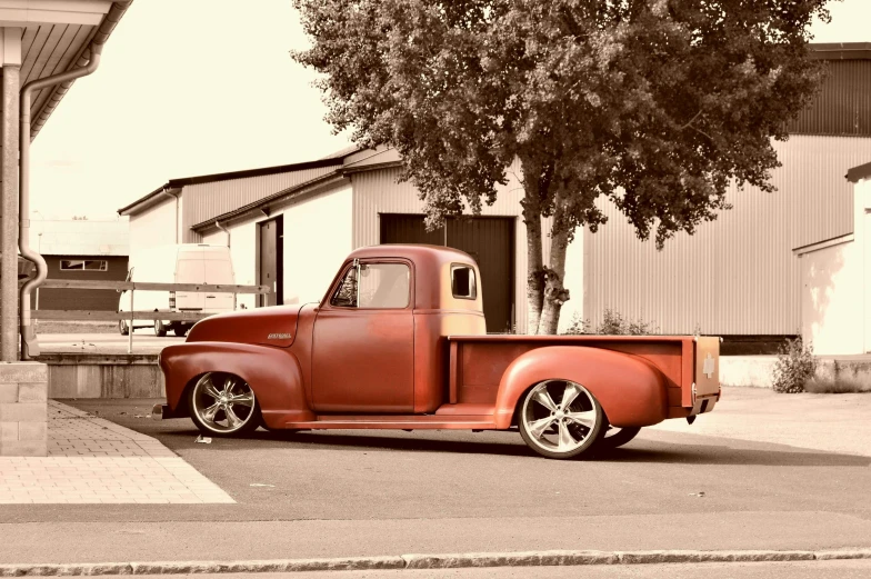 an old red truck parked on the side of the road, a colorized photo, pexels contest winner, brushed rose gold car paint, perfectly shaded body, taken in the late 2010s, in front of a garage