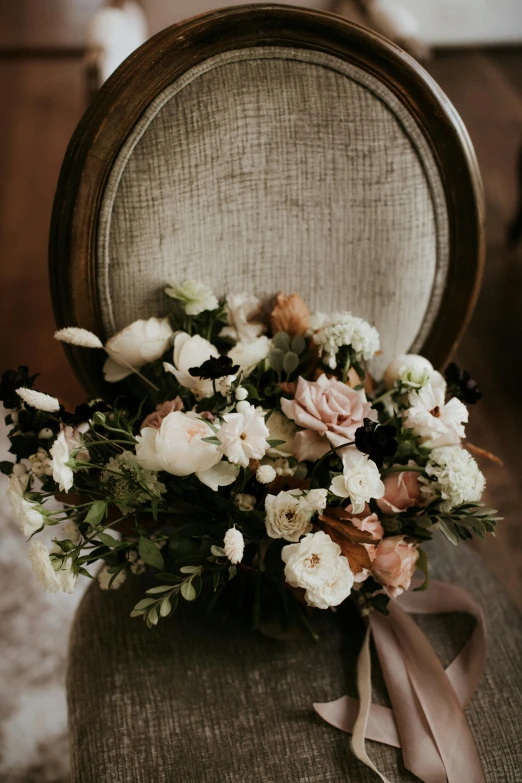 a bouquet of flowers sitting on top of a chair, by Robbie Trevino, beautiful natural soft rim light, dark sienna and white, rustic setting, soft blush