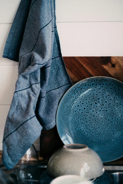 a blue dish sitting on top of a counter next to a towel, inspired by Lewis Henry Meakin, trending on unsplash, dwell, layered texture, patterned, vendors