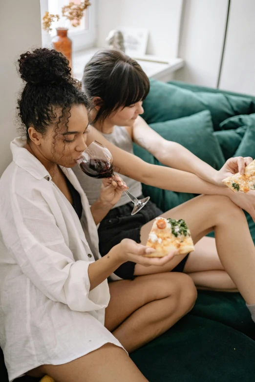 three women sitting on a couch eating pizza and drinking wine, by Adam Marczyński, trending on unsplash, sexy sesame seed buns, pastel', two buddies sitting in a room, steamed buns
