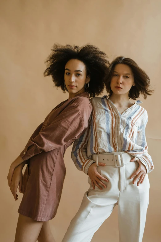 a couple of women standing next to each other, trending on pexels, renaissance, brown shirt, mixed styles, wavy hair spread out, in muted colours