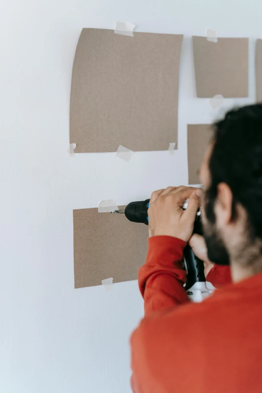 a man using a drill to paint a wall, by artist, pexels contest winner, cut out of cardboard, inspect in inventory image, portrait photo, ebay listing thumbnail