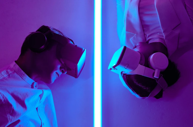 a man in a white shirt wearing a pair of headphones, inspired by Beeple, unsplash, interactive art, wrestlers wearing vr headsets, blue and purple lighting, twins playing video games, cardboard