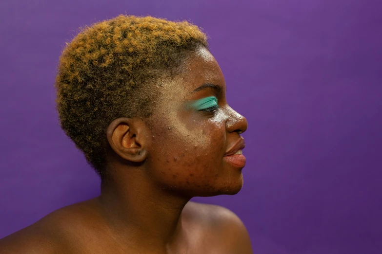 a close up of a person with a purple background, inspired by Elsa Bleda, trending on pexels, afrofuturism, pimples, brown skin, green skin, beauty mark on cheek