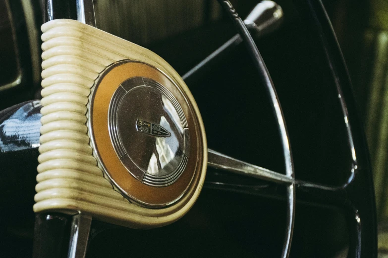 a close up of a steering wheel on a car, an album cover, pexels contest winner, retrofuturism, interior wood, 2030s, desk fan, detailed color scan”