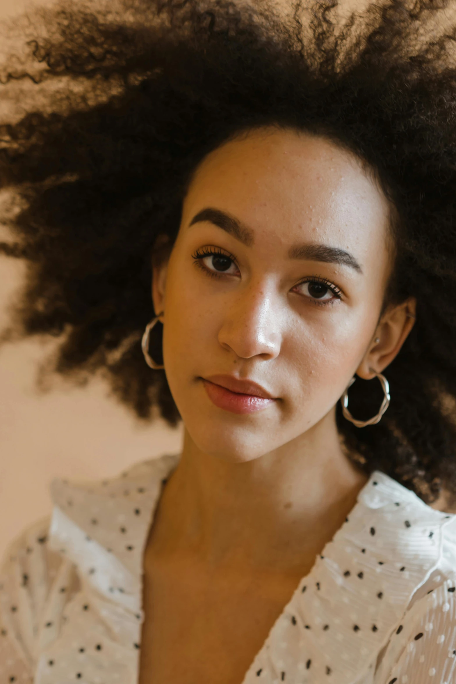 a close up of a person with a cell phone, a character portrait, by Lily Delissa Joseph, trending on pexels, hoop earrings, ashteroth, portrait sophie mudd, big hair