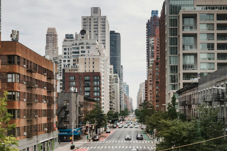 a city street filled with lots of tall buildings, inspired by Thomas Struth, unsplash contest winner, renaissance, harlem, 3 / 4 wide shot, dwell, schools