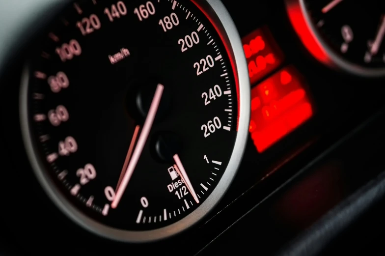 a close up of a speedometer in a car, a digital rendering, by Thomas Häfner, unsplash, bmw e 3 0, red rim light, stacked image, 2 4 0 p footage