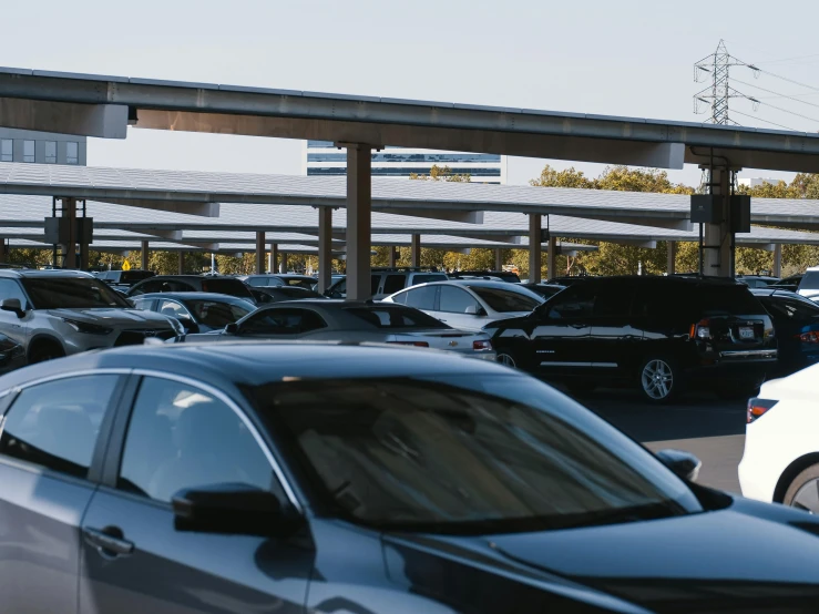 a parking lot filled with lots of parked cars, unsplash, happening, southdale center, webdesign icon for solar carport, view from ground level, ignant