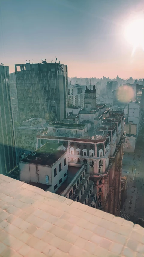 a view of a city from the top of a building, inspired by Elsa Bleda, hyperrealism, buenos aires, low quality photo, sunfaded, city morning