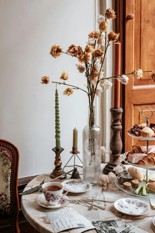 a table that has a bunch of food on it, inspired by Pierre-Joseph Redouté, trending on unsplash, baroque, brown flowers, morning detail, mixed materials, indoor shot