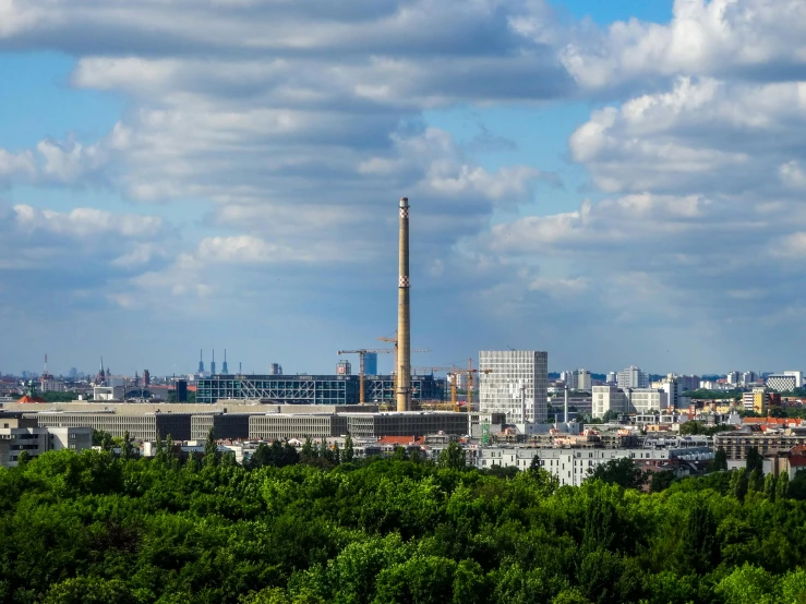 a view of a city from the top of a hill, by Sven Erixson, pexels contest winner, bauhaus, industrial plant environment, saint petersburg, tall metal towers, seen from a distance