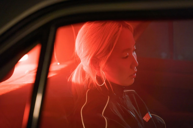 a woman sitting in the passenger seat of a car, an album cover, inspired by Elsa Bleda, heonhwa choe, red door blonde, profile image