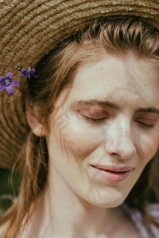 a woman wearing a straw hat with a flower in her hair, inspired by Violet Oakley, trending on pexels, closeup of sweating forehead, patchy flowers, beauty mark on cheek, shy looking down