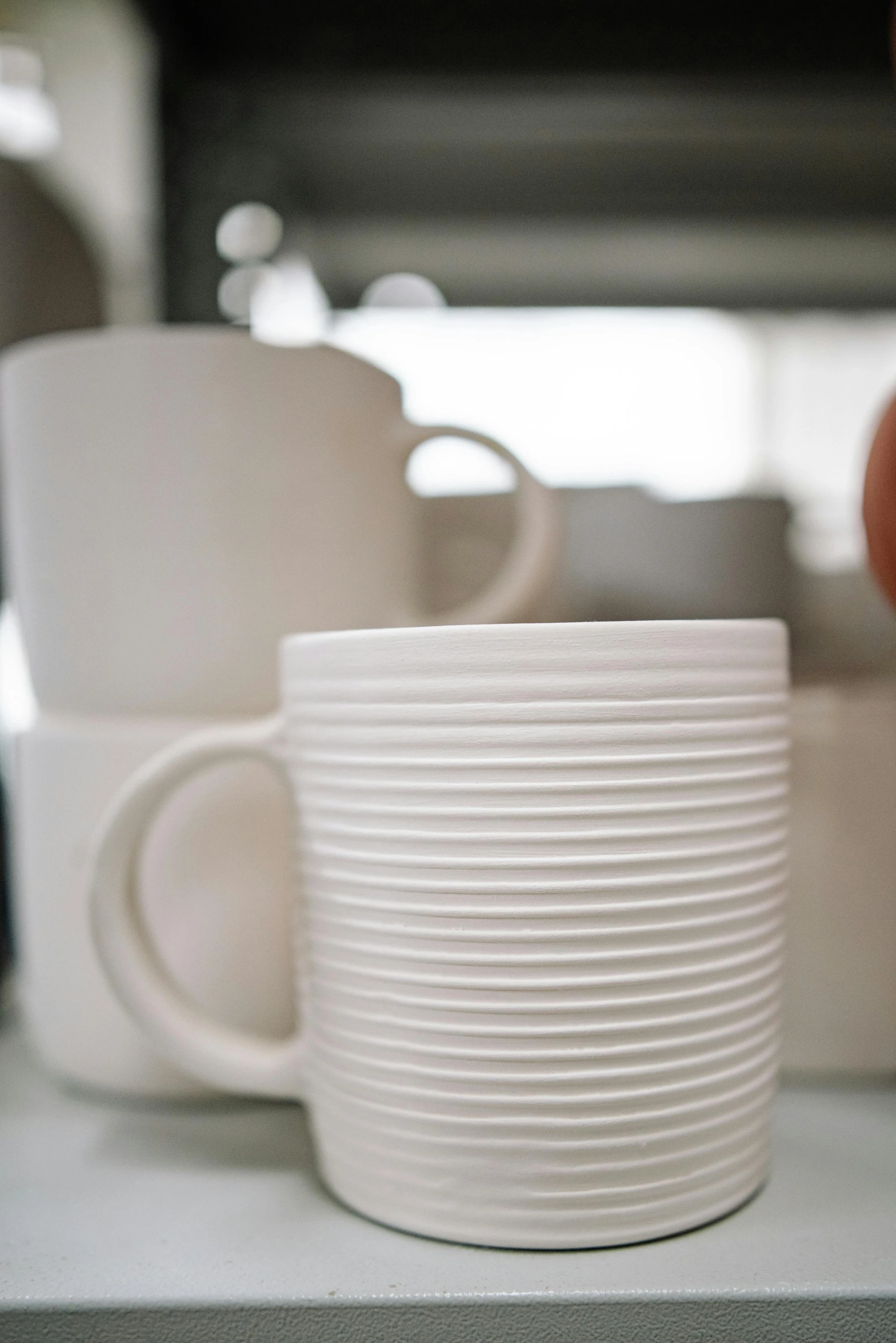 a stack of coffee cups sitting on top of a counter, a still life, unsplash, process art, 3d printed line texture, a pair of ribbed, super detail of each object, no - text no - logo