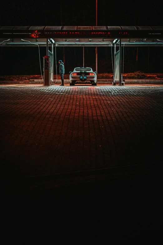 a car parked at a gas station at night, by Tobias Stimmer, pexels contest winner, postminimalism, sportcar, gif, standing under a beam of light, abandoned night hangar