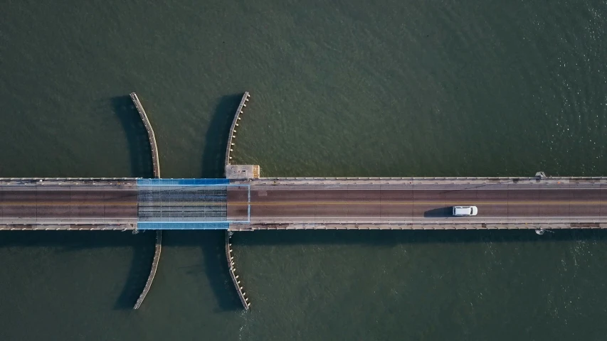 a long bridge over a body of water, by Jacob Toorenvliet, pexels contest winner, hurufiyya, top - down, new york harbour, thumbnail, dutch tilt