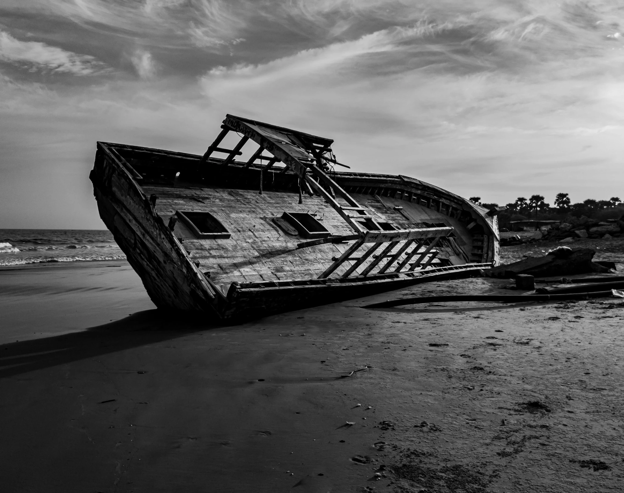 a black and white photo of a boat on the beach, a black and white photo, by Alexander Robertson, unsplash contest winner, surrealism, destroyed ship, victorian, abel tasman, quarter view