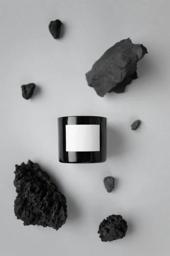 a black candle surrounded by black rocks, a black and white photo, unsplash, conceptual art, photoshoot for skincare brand, jar on a shelf, aesthetic / a riot in mars, 3 d product render