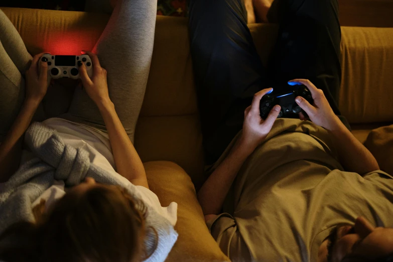 two people laying on a couch playing a video game, trending on pexels, bottom angle, evening time, avatar image, panoramic shot