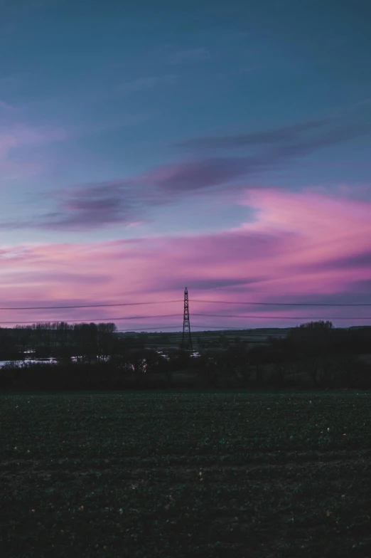 a sunset over a field with power lines in the distance, by Sam Charles, aestheticism, mauve and cyan, high quality image