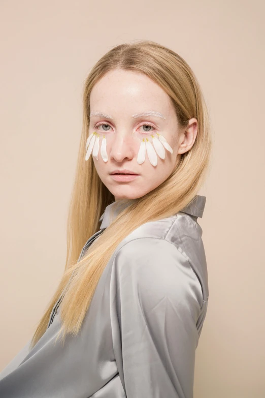 a woman with white paint on her face, an album cover, by Maud Naftel, at a fashion shoot, long crooked nose, silicone skin, trending photo