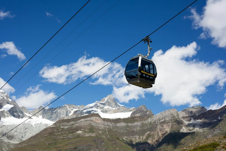 a gondola going up the side of a mountain, by Werner Andermatt, pexels contest winner, blue sky, trams, avatar image, glaciers