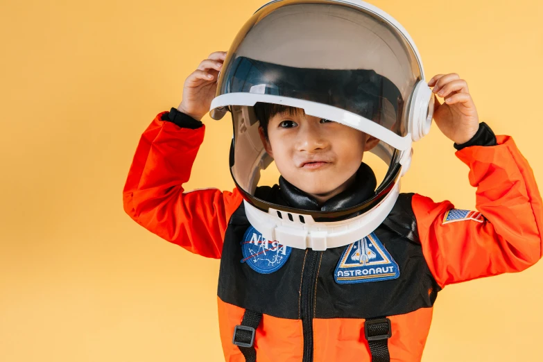 a young boy wearing a space suit and helmet, pexels contest winner, avatar image, girl wearing uniform, headspace, wearing a fancy dress