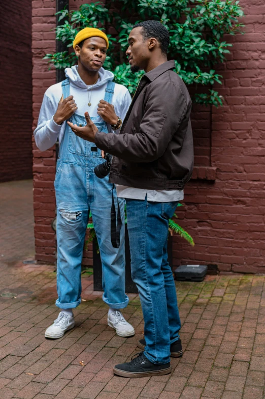 a couple of men standing next to each other, a photo, trending on pexels, renaissance, torn overalls, riyahd cassiem, on location, ( ( theatrical ) )