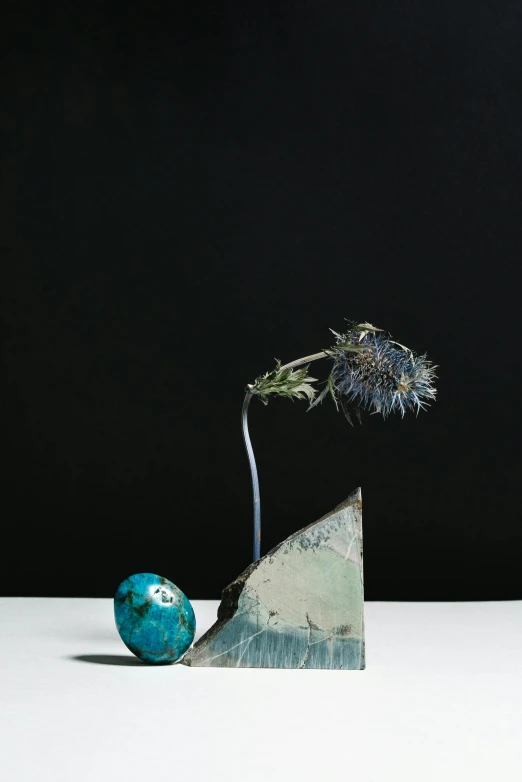 a blue vase sitting on top of a white table, a surrealist sculpture, by artist, unsplash, new sculpture, thistles, david kassan, painted metal and glass, lunar
