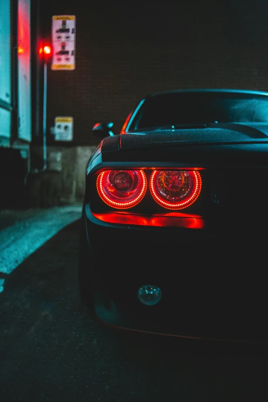 a car parked on the side of the road at night, red tail lights, unsplash photo contest winner, soft color dodge, closeup portrait shot