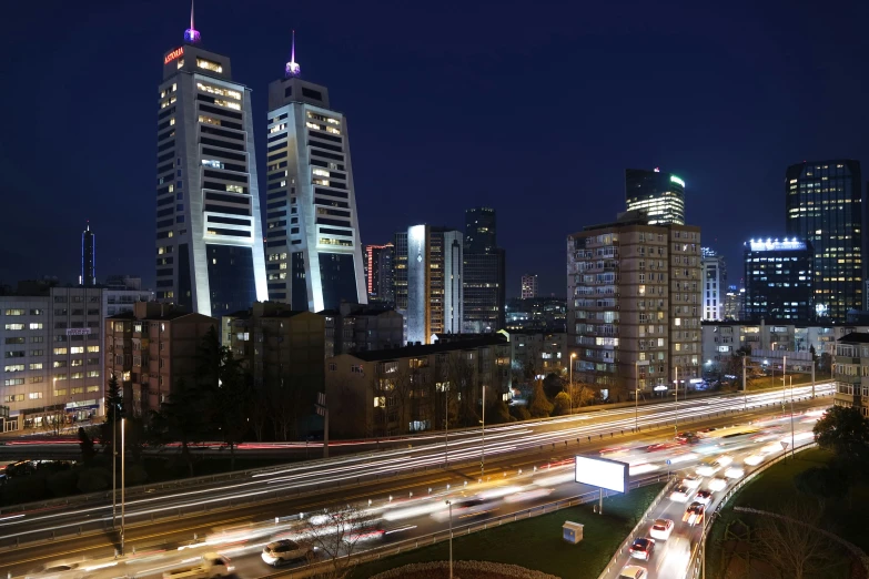 a city filled with lots of traffic next to tall buildings, by Adam Marczyński, pexels contest winner, hyperrealism, islamic, night time footage, byzantine, 2000s photo