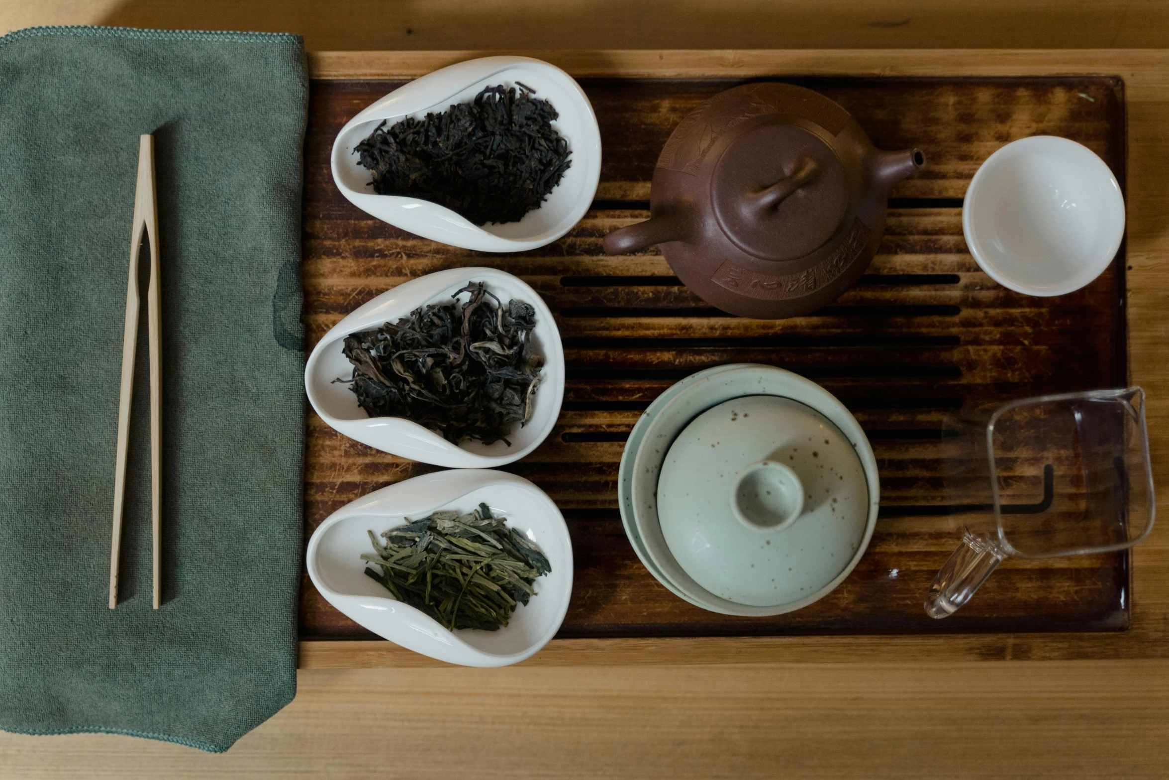 a wooden tray topped with bowls of tea and chopsticks, a portrait, trending on unsplash, fan favorite, medium close shot, asleep, group photo