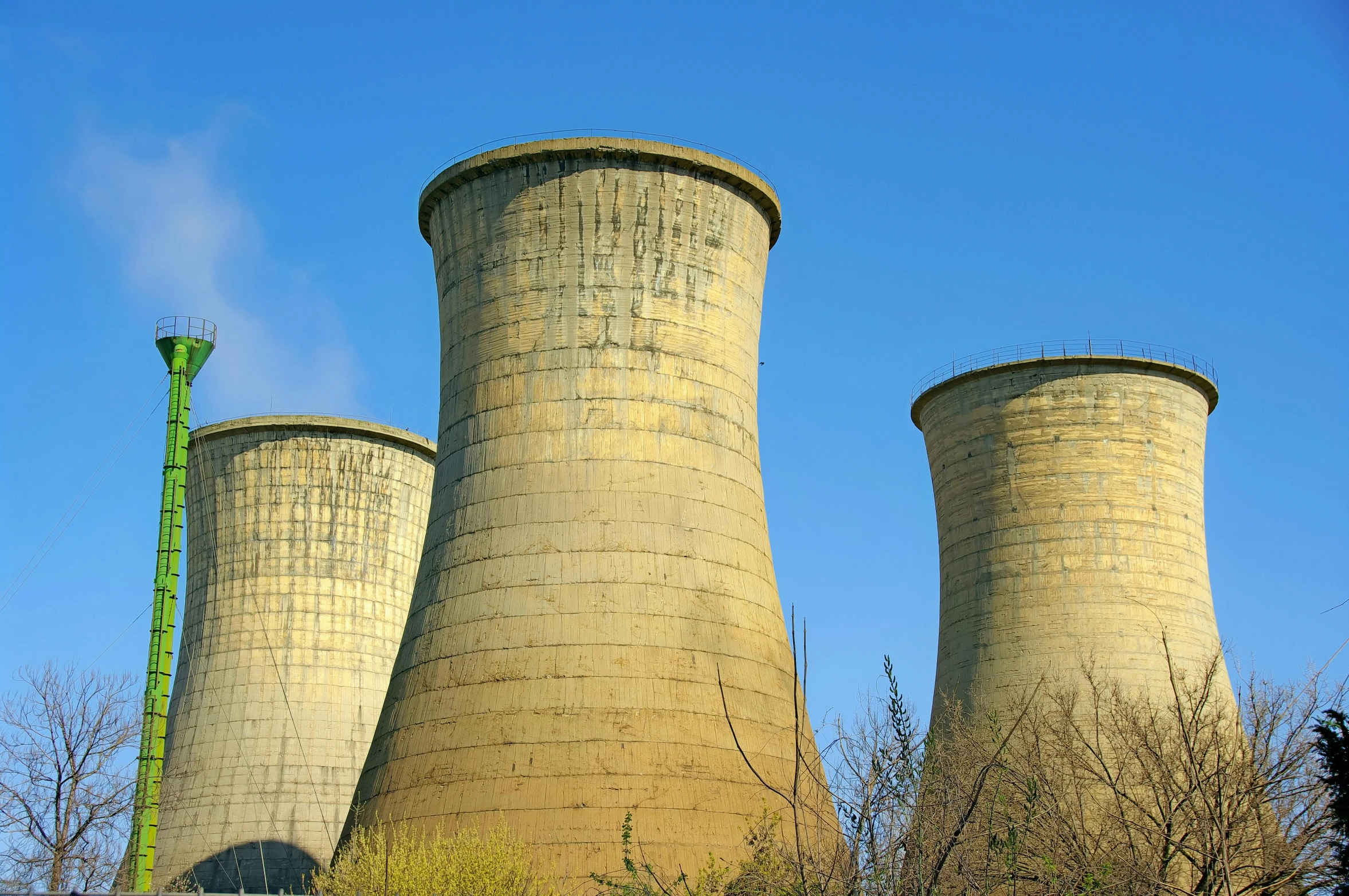 a couple of cooling towers sitting next to each other, inspired by George Fiddes Watt, unsplash, nuclear art, three towers, thumbnail, 1940s photo, ripley scott