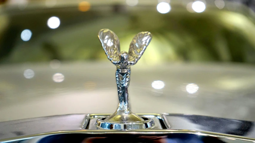 a close up of a car hood ornament, an art deco sculpture, unsplash, wings spread, video still, faberge, on display