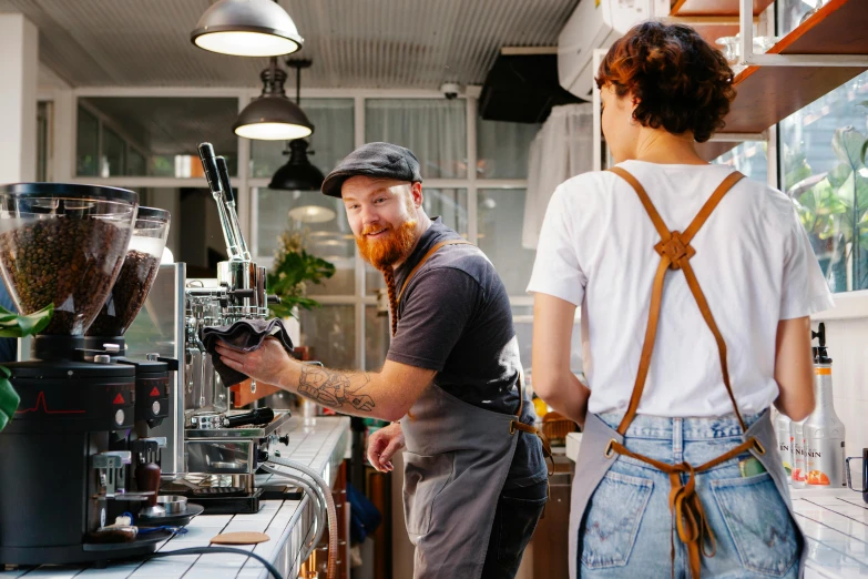 a couple of men standing next to each other in a kitchen, by Lee Loughridge, pexels contest winner, aussie baristas, highly mechanical, at checkout, avatar image