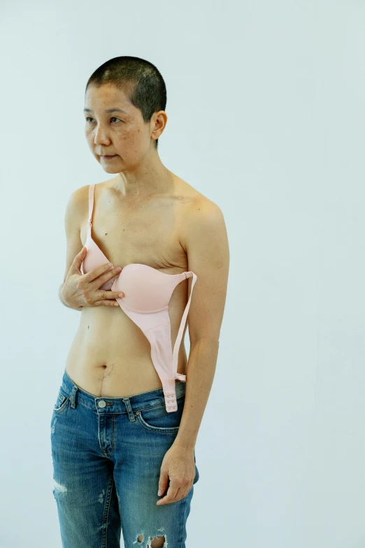 a woman in a pink bra top posing for a picture, inspired by Zhang Kechun, unsplash, conceptual art, marfan syndrome, mai anh tran, full extremely slim body, 4 5 yo