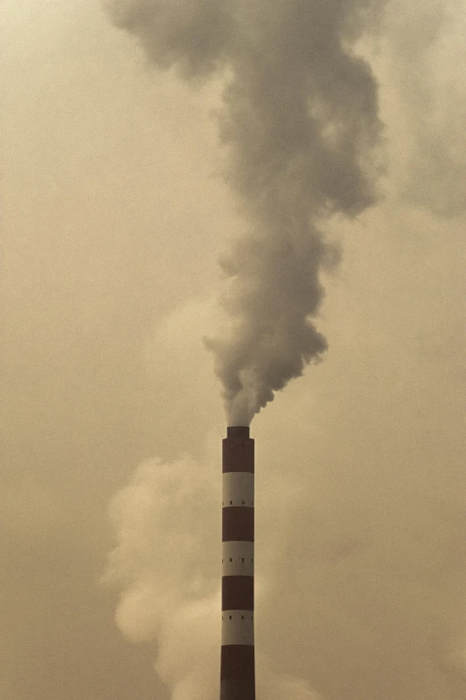 a factory that has a lot of smoke coming out of it, flickr, sepia colors, chimney with smoke, india, clemens ascher