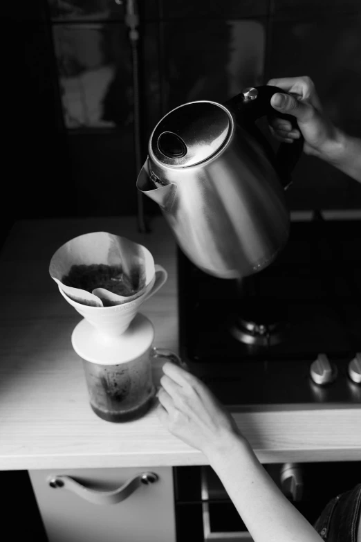 a black and white photo of a woman pouring a cup of coffee, process art, lo - fi, bells, medium format, ffffound